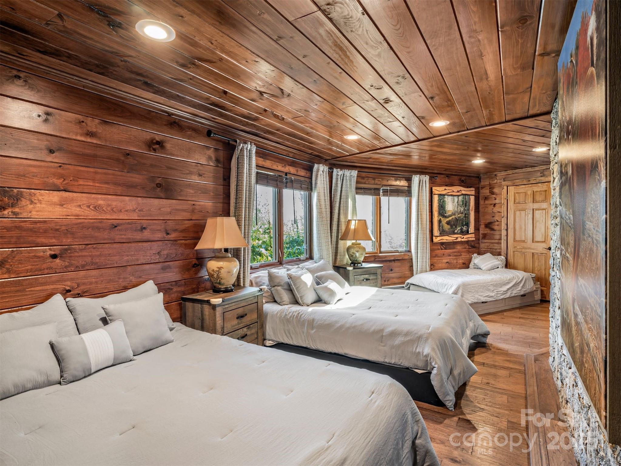135 Grouse Point Road Maggie Valley, NC 28751 - Photo 32 of 48 a bedroom with furniture and a large window