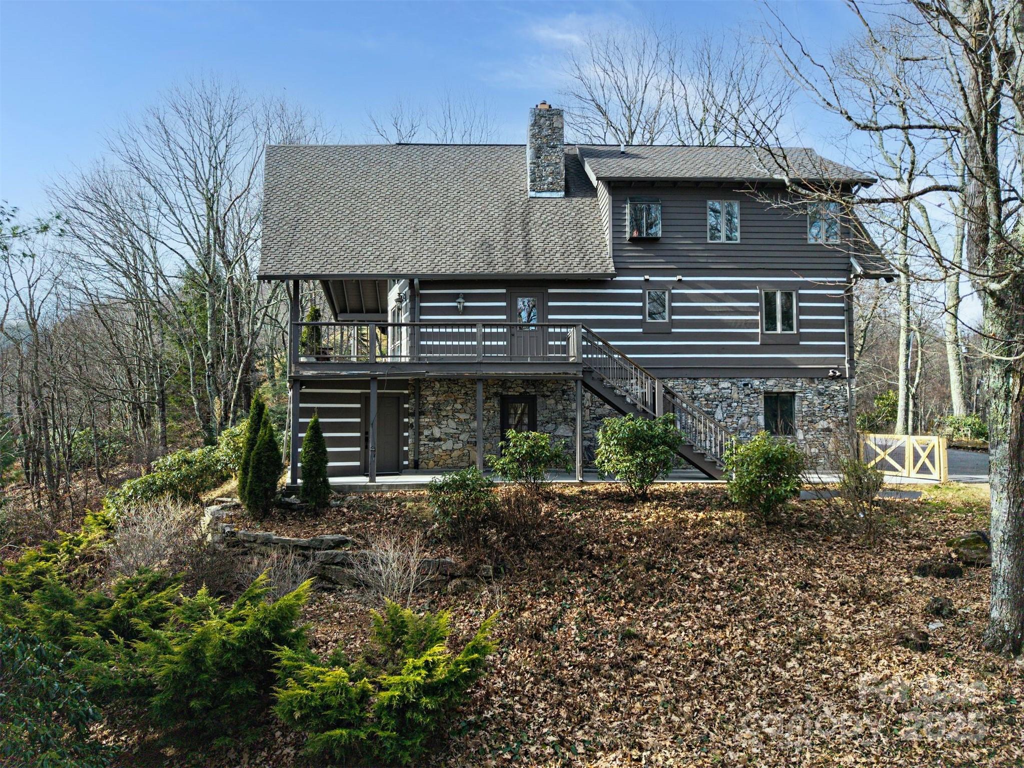 135 Grouse Point Road Maggie Valley, NC 28751 - Photo 40 of 48 a front view of a house with garden