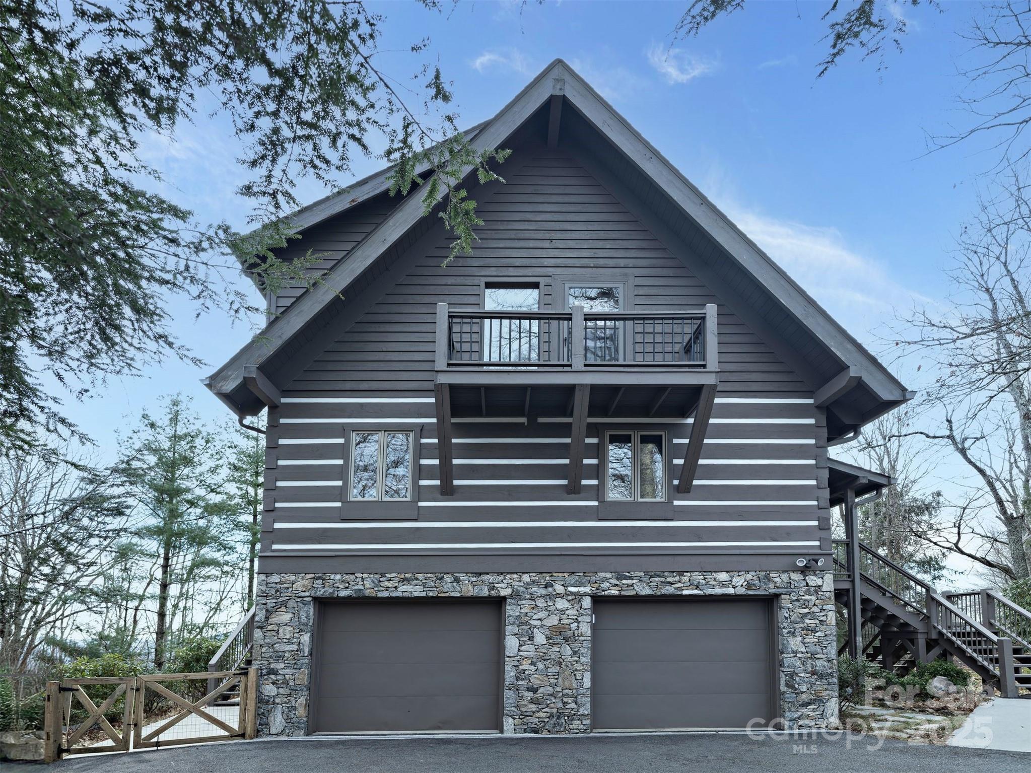 135 Grouse Point Road Maggie Valley, NC 28751 - Photo 42 of 48 a front view of a house with a balcony