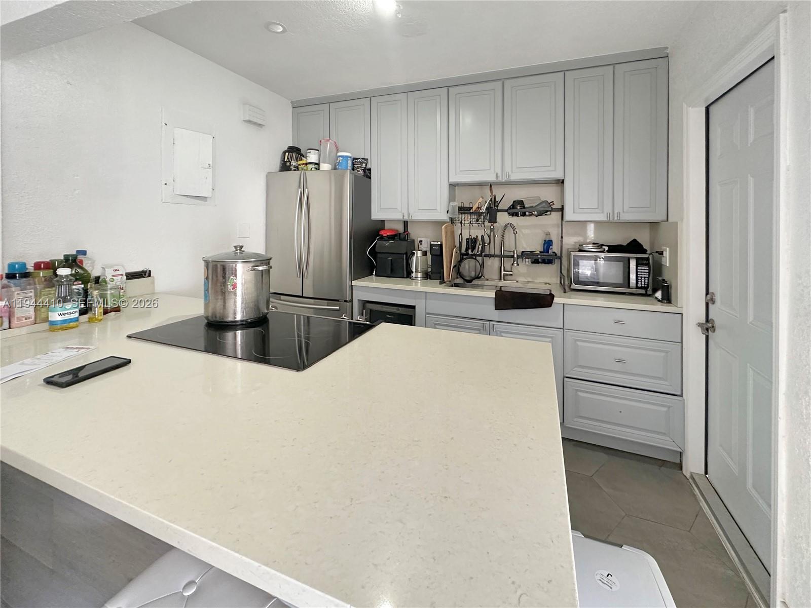 971 79th Terrace Miami Beach, FL 33141 - Photo 1 of 11 a kitchen with refrigerator and cabinets