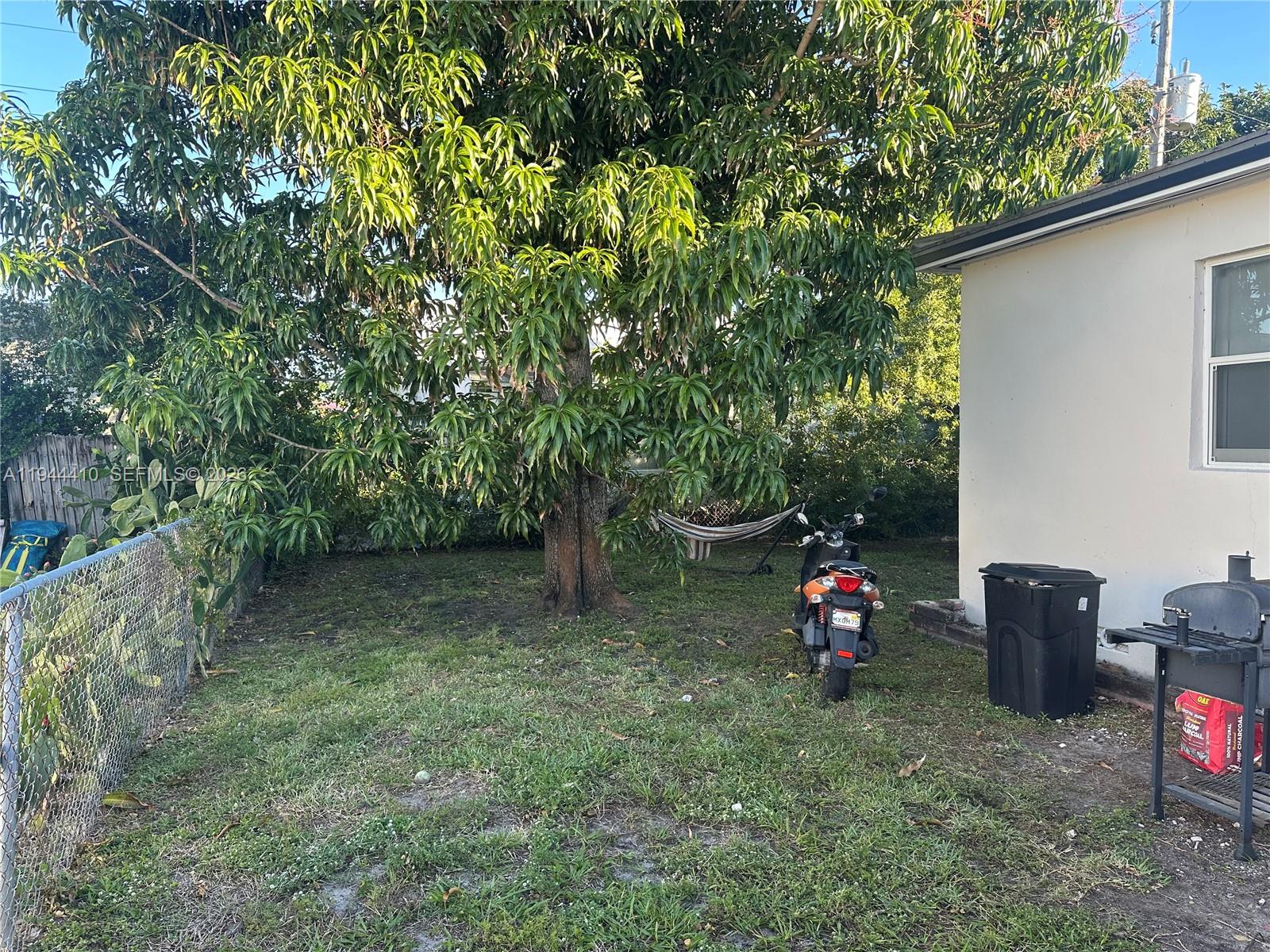 971 79th Terrace Miami Beach, FL 33141 - Photo 11 of 11 a view of a backyard with a table and a chairs