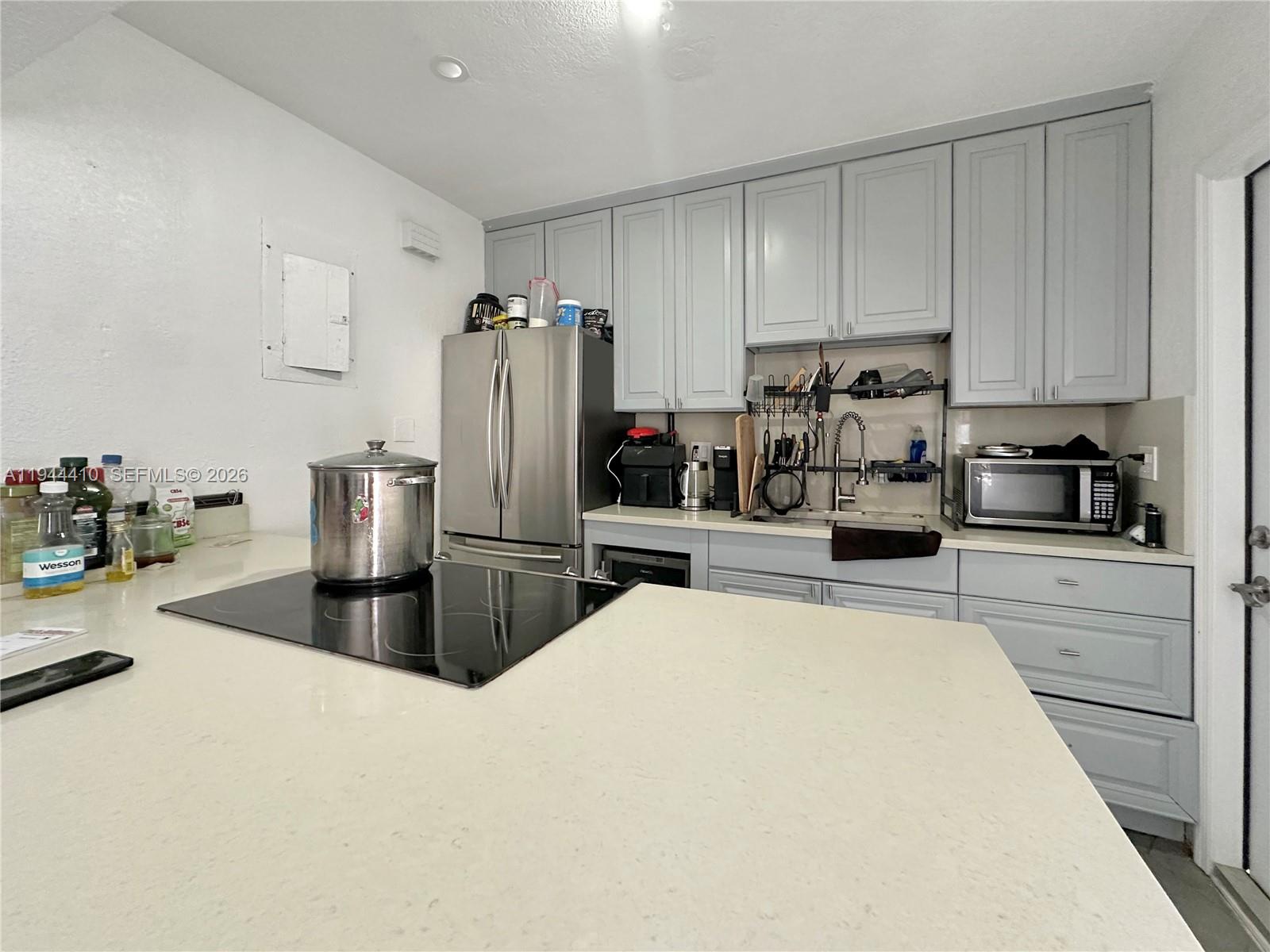 971 79th Terrace Miami Beach, FL 33141 - Photo 2 of 11 a kitchen with stainless steel appliances a refrigerator sink and stove