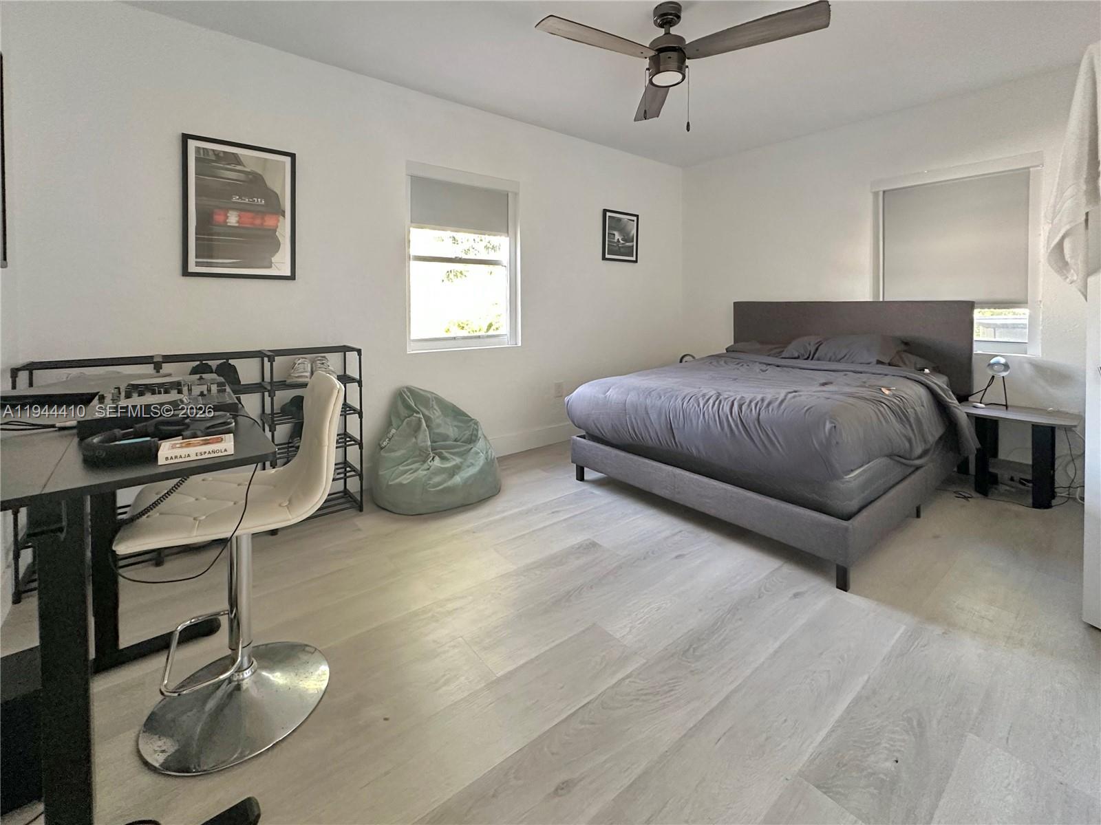 971 79th Terrace Miami Beach, FL 33141 - Photo 4 of 11 a bedroom with a bed and dresser with mirror