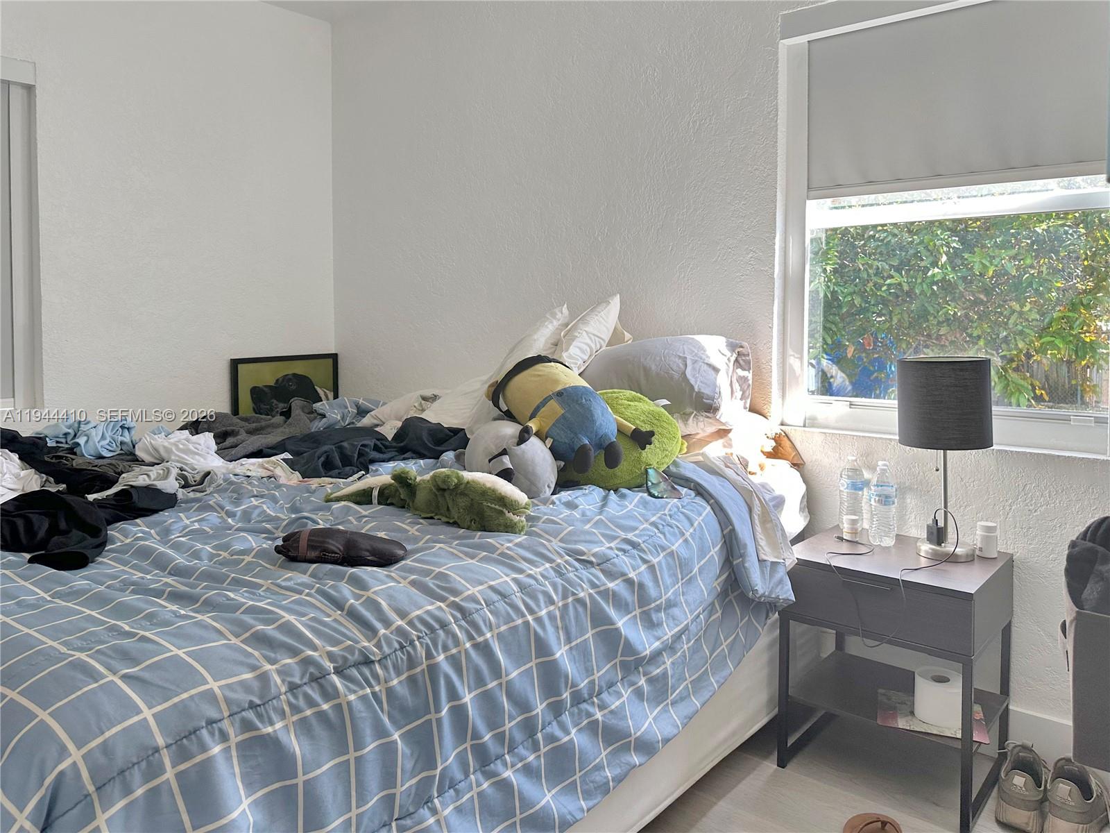 971 79th Terrace Miami Beach, FL 33141 - Photo 5 of 11 a bedroom with two beds and a potted plant