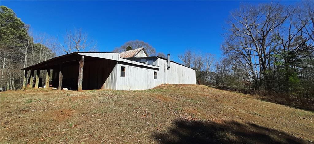 11953 Henderson Mountain Road Fairmount, GA 30139 - Photo 16 of 46 a view of a house with a yard