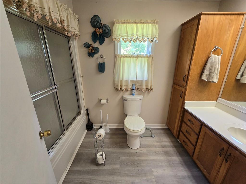 11953 Henderson Mountain Road Fairmount, GA 30139 - Photo 43 of 46 a bathroom with a sink a toilet a window and tub