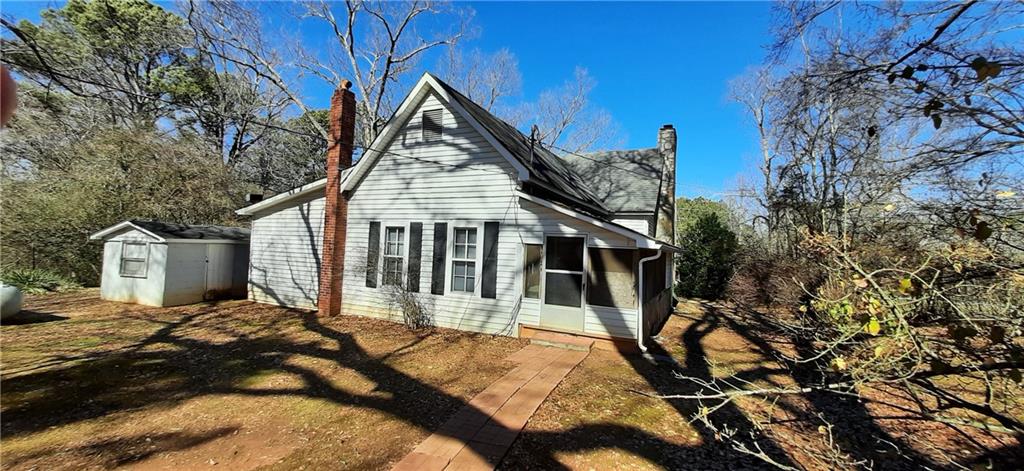 11953 Henderson Mountain Road Fairmount, GA 30139 - Photo 10 of 46 a view of a house with a small yard and wooden fence
