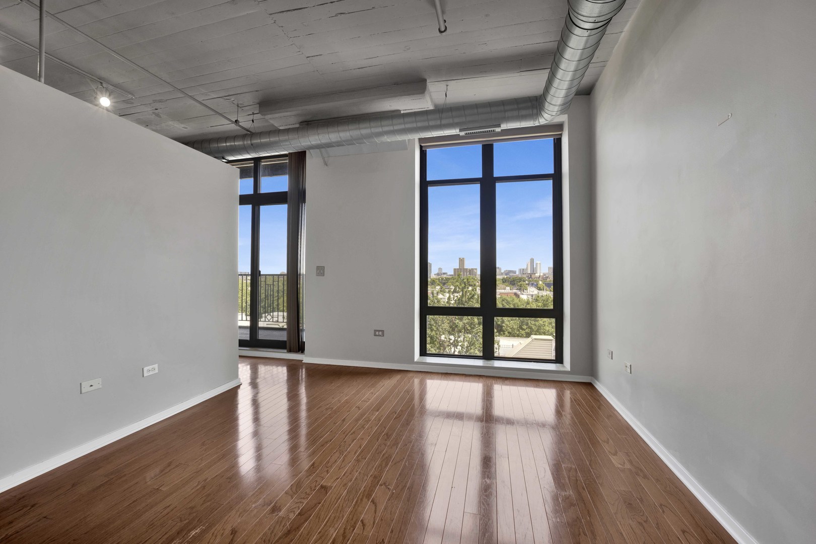 1525 South Sangamon Street, Unit 504 Chicago, IL 60608 - Photo 18 of 32 an empty room with wooden floor and windows
