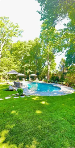 a view of yard with swimming pool and green space