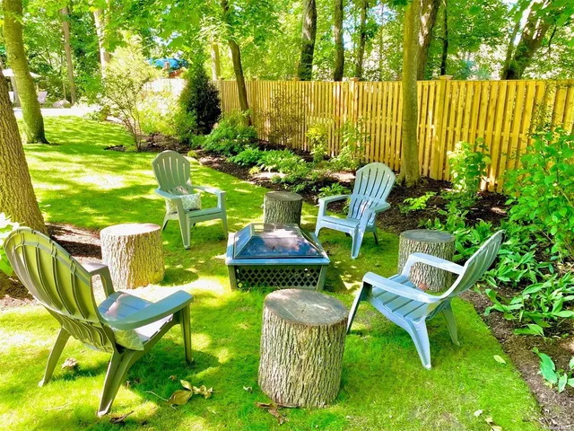 a view of an chairs and table in the garden