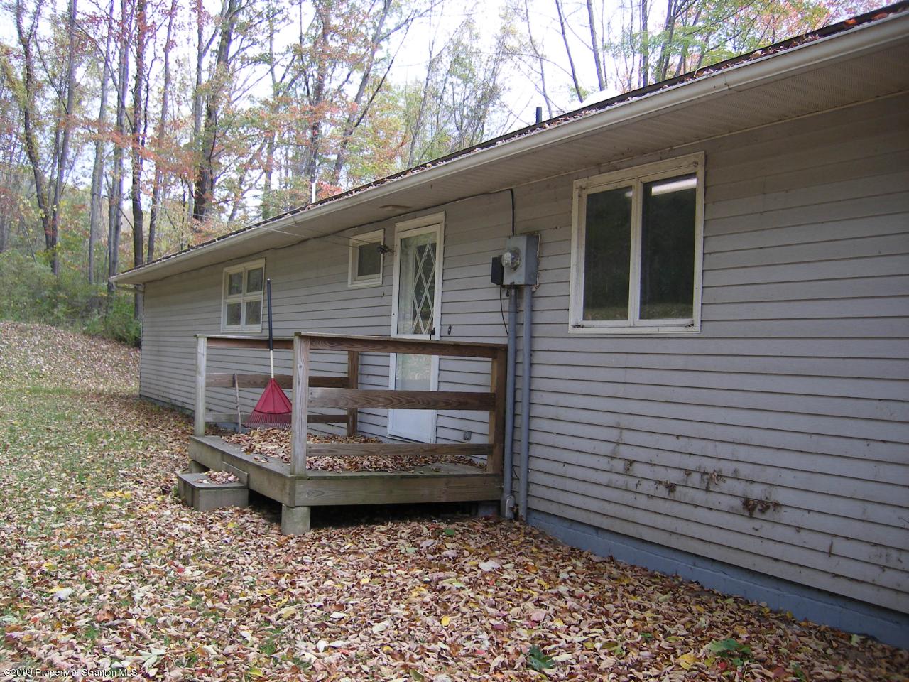252 Lane Hill Road Tunkhannock, PA 18657 - Photo 6 of 8 a view of a wooden house with a yard and large tree
