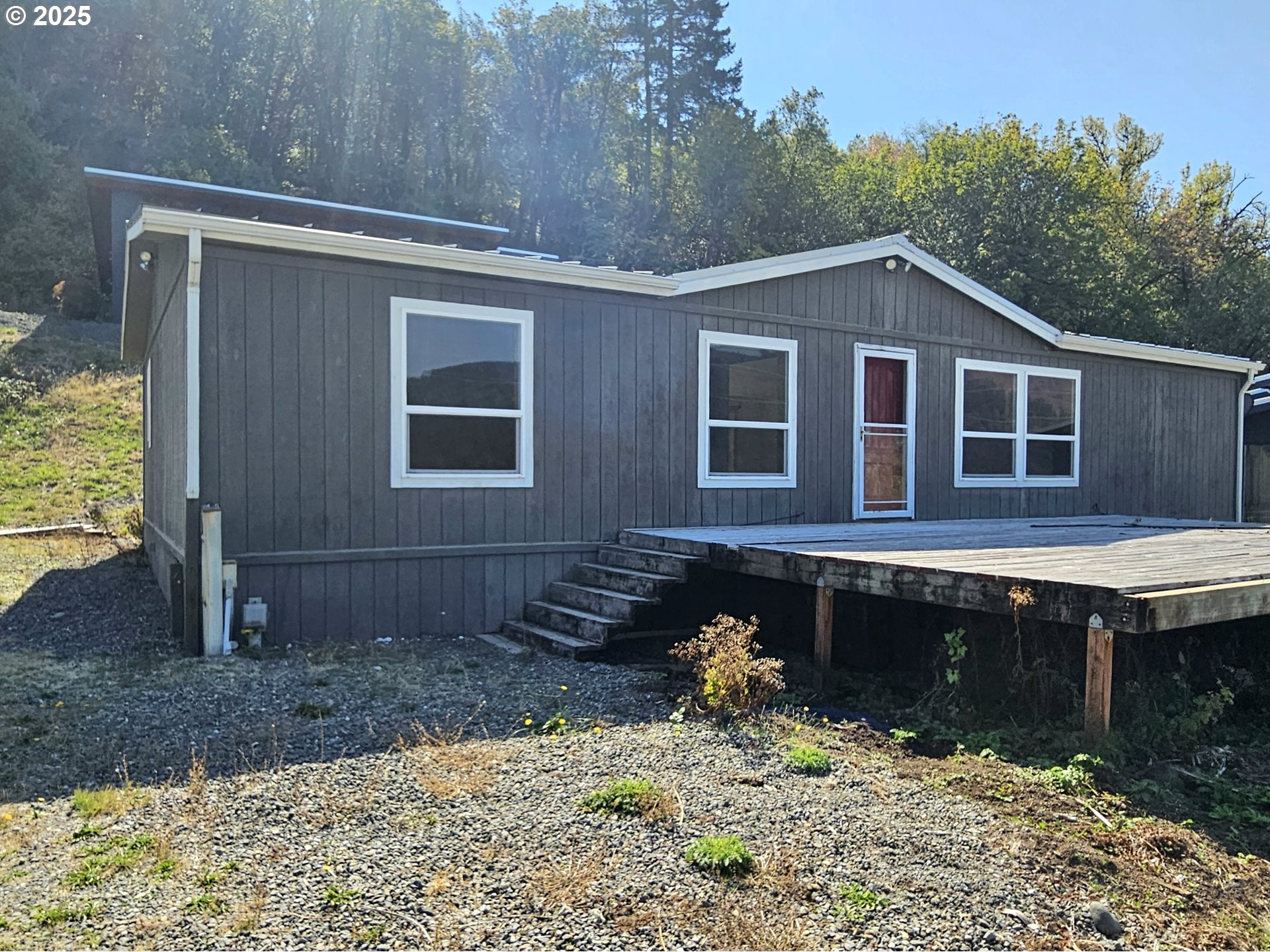 Undisclosed Address Brookings, OR 97415 - Photo 1 of 13 a front view of a house with a yard