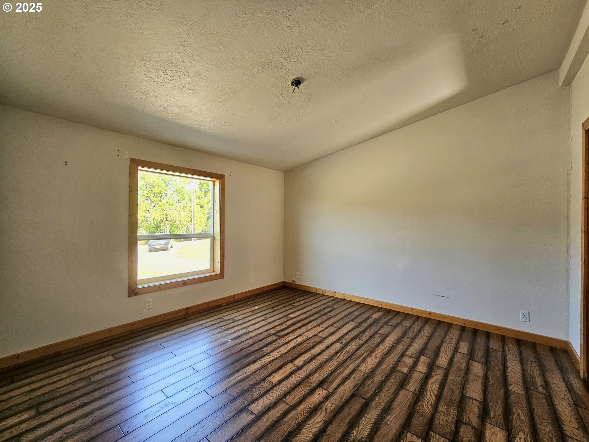 Undisclosed Address Brookings, OR 97415 - Photo 12 of 13 an empty room with wooden floor and windows