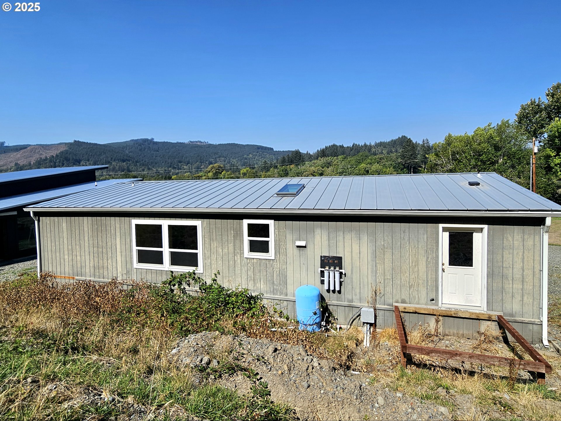 Undisclosed Address Brookings, OR 97415 - Photo 3 of 13 a house view with a backyard space