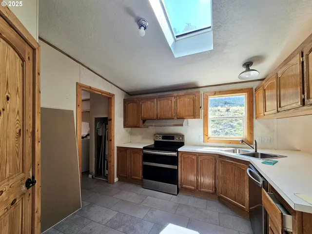 a kitchen with a sink cabinets and stainless steel appliances