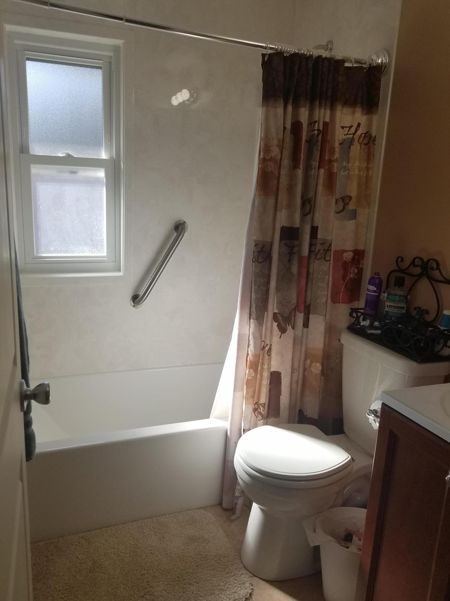 109 Tucker Road Oak Ridge, TN 37830 - Photo 12 of 20 a white toilet sitting next to a bathroom sink and tub