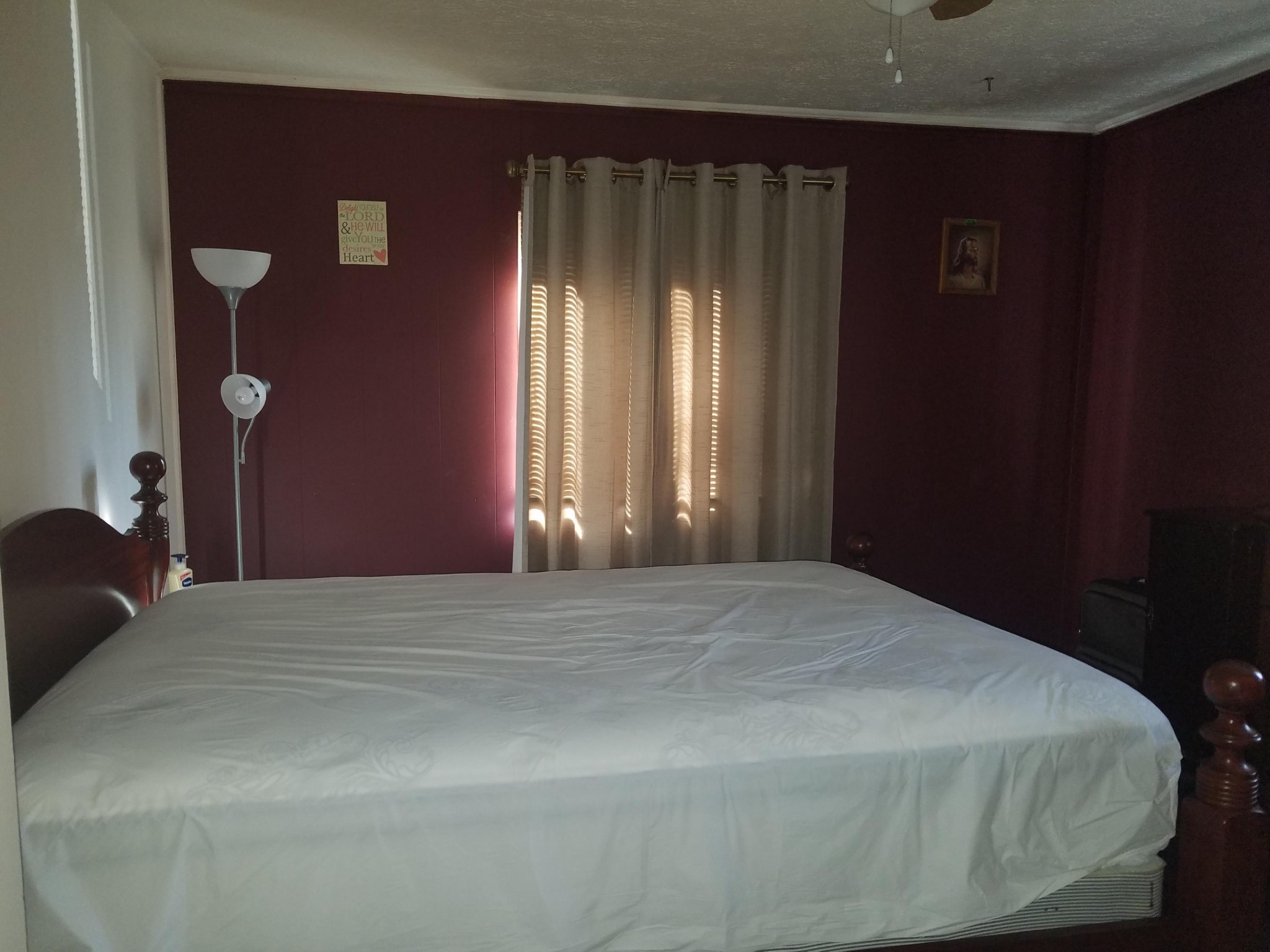 109 Tucker Road Oak Ridge, TN 37830 - Photo 13 of 20 a bed sitting in a bedroom next to a window and a mirror