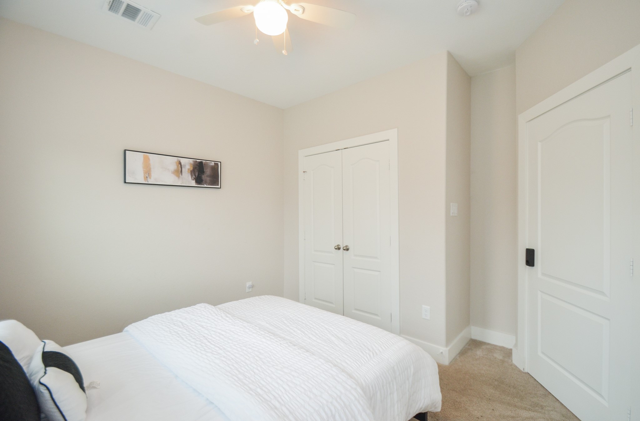 4511 Reed Road Houston, TX 77051 - Photo 35 of 39 a bedroom with a bed and a chandelier