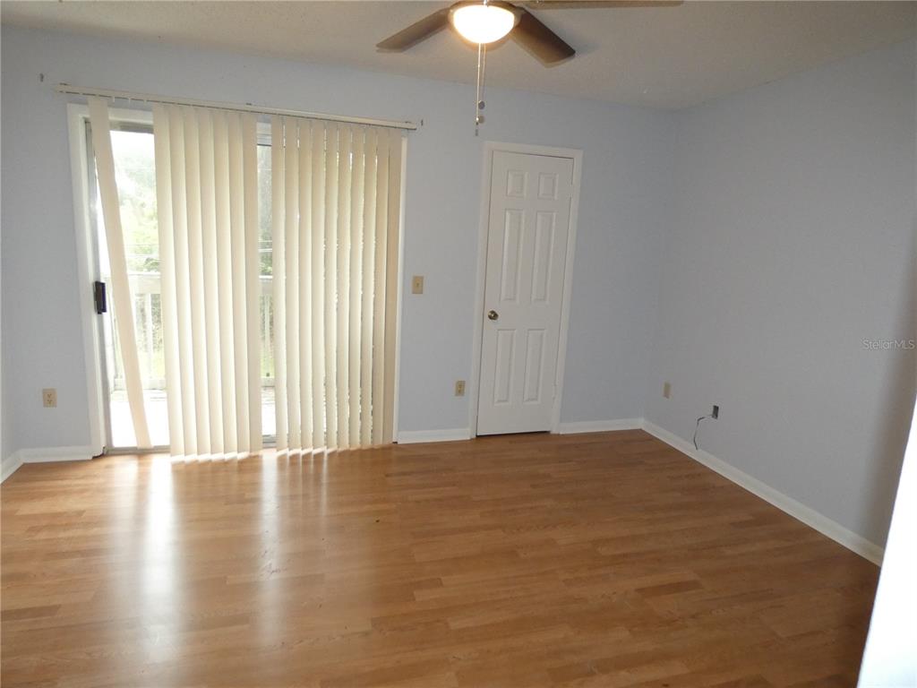 12080 Mendel Drive Orlando, FL 32826 - Photo 6 of 10 a view of an empty room with wooden floor and a window