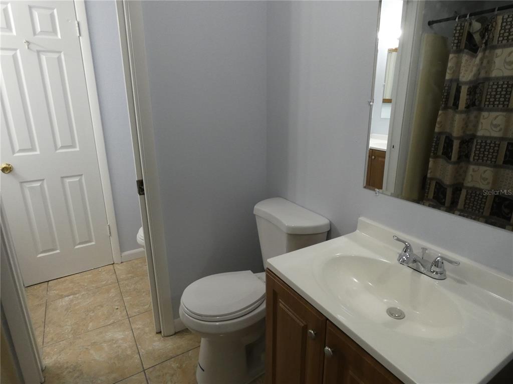 12080 Mendel Drive Orlando, FL 32826 - Photo 8 of 10 a bathroom with a sink a toilet and shower