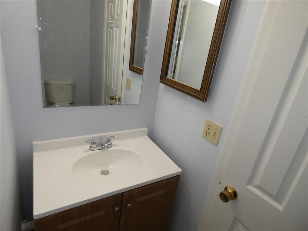 12080 Mendel Drive Orlando, FL 32826 - Photo 9 of 10 a bathroom with a sink a mirror and vanity