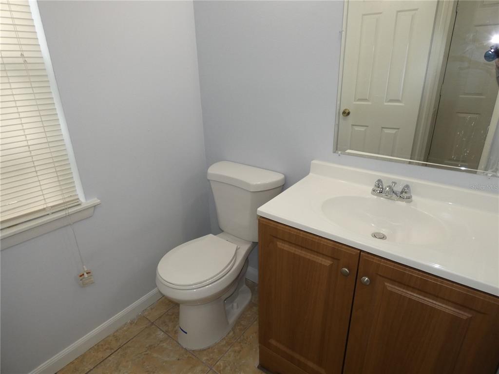 12080 Mendel Drive Orlando, FL 32826 - Photo 10 of 10 a bathroom with a sink a toilet and a mirror