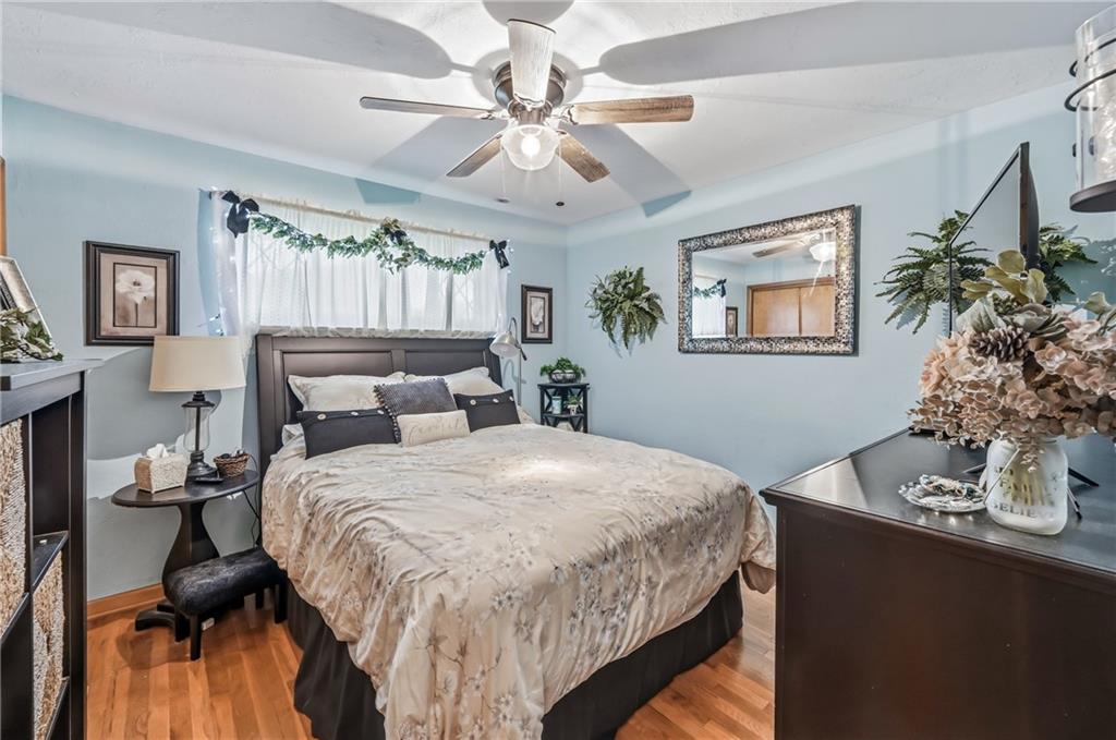 409 Patt Drive Farrell, PA 16121 - Photo 25 of 50 a bedroom with a large bed and a chandelier