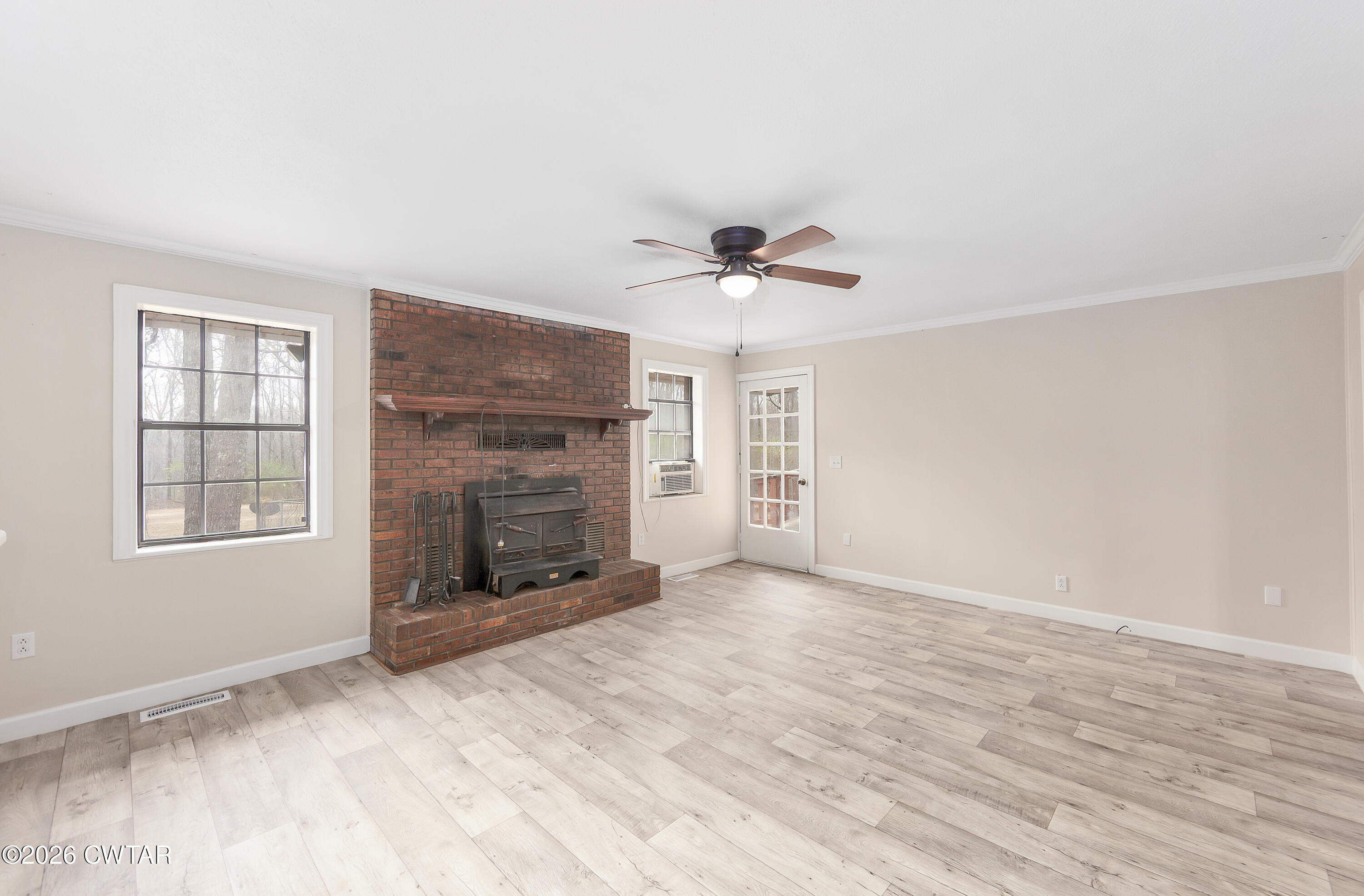 192 New Salem Road Bethel Springs, TN 38315 - Photo 11 of 32 a view of an empty room with a fireplace and a window