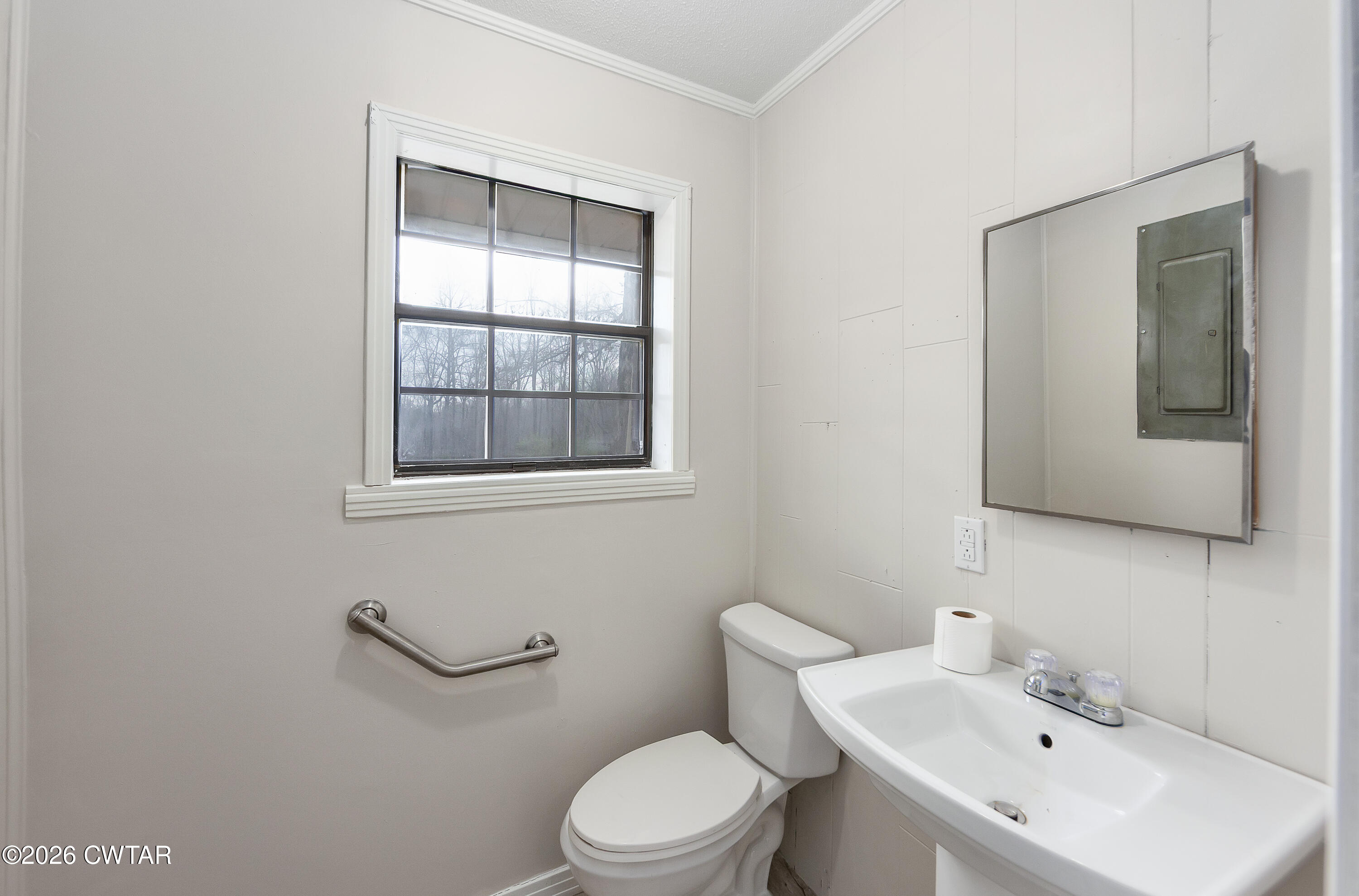 192 New Salem Road Bethel Springs, TN 38315 - Photo 14 of 32 a bathroom with a toilet a sink and mirror