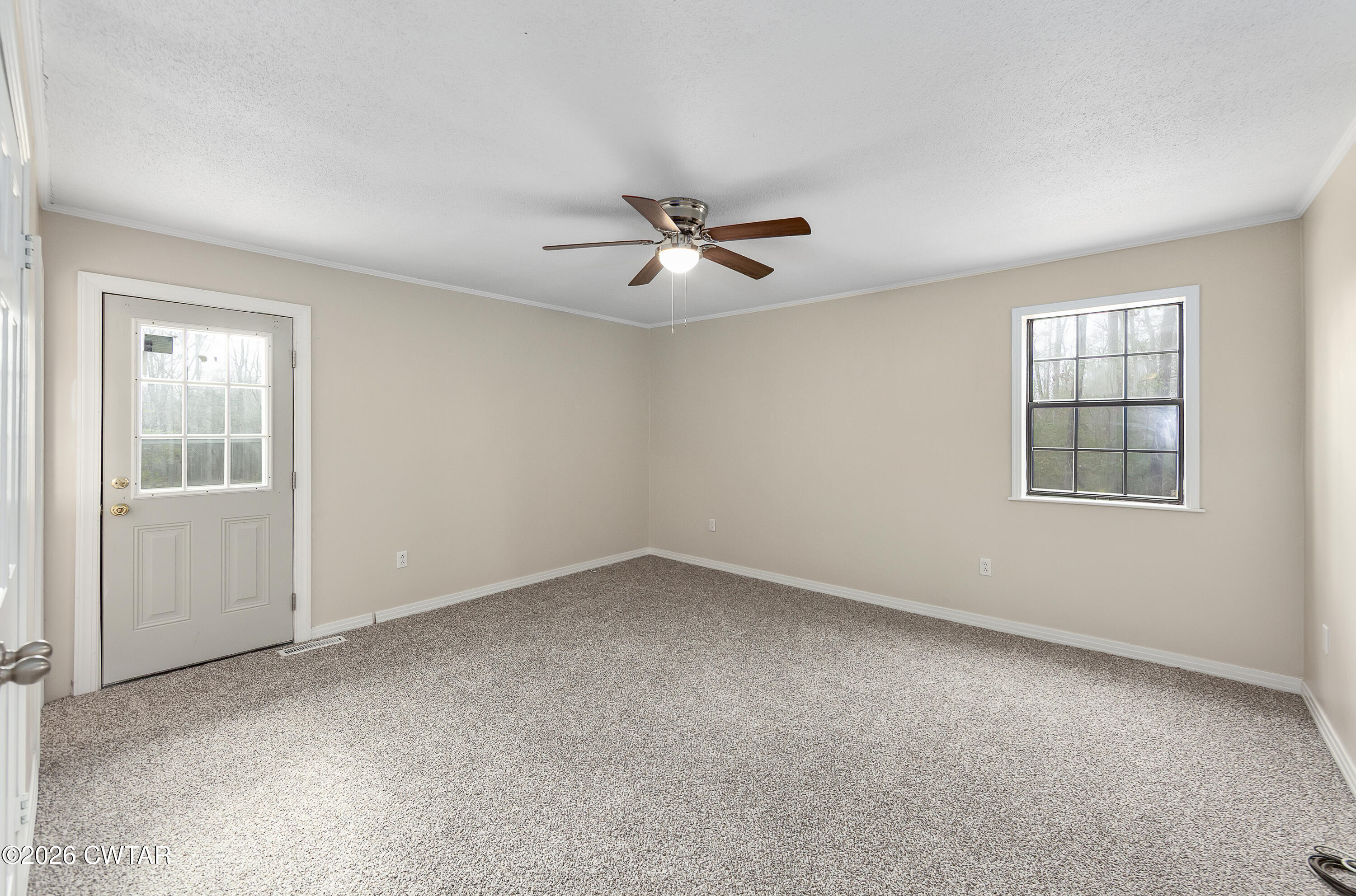 192 New Salem Road Bethel Springs, TN 38315 - Photo 20 of 32 an empty room with chandelier fan and windows