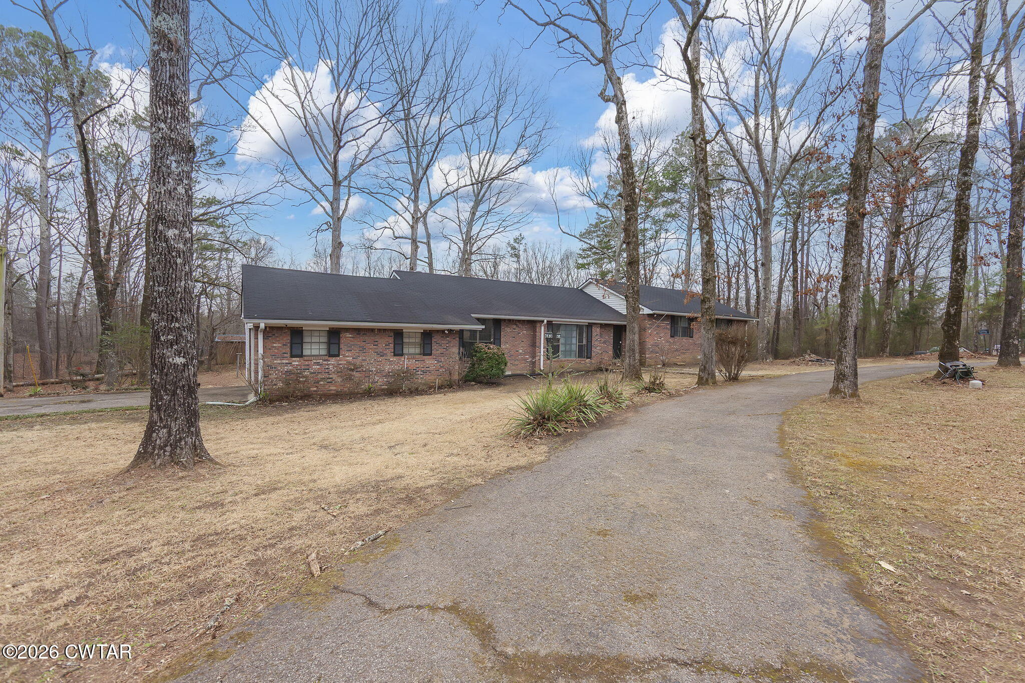 192 New Salem Road Bethel Springs, TN 38315 - Photo 23 of 32 a front view of a house with a dirt yard and a large tree