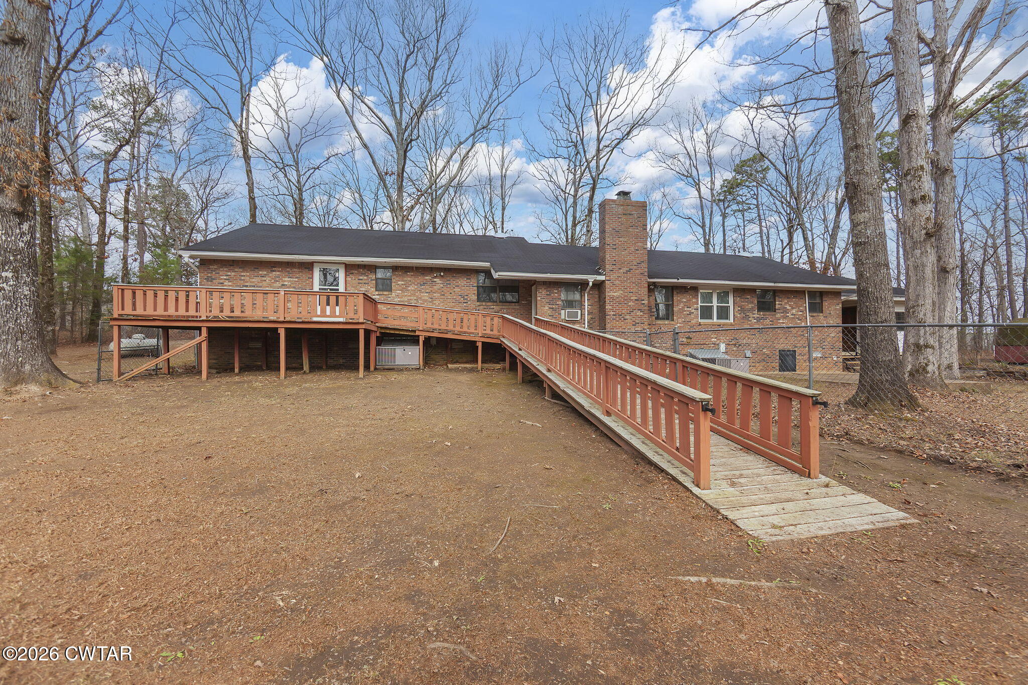 192 New Salem Road Bethel Springs, TN 38315 - Photo 24 of 32 a view of a house with wooden deck and trees