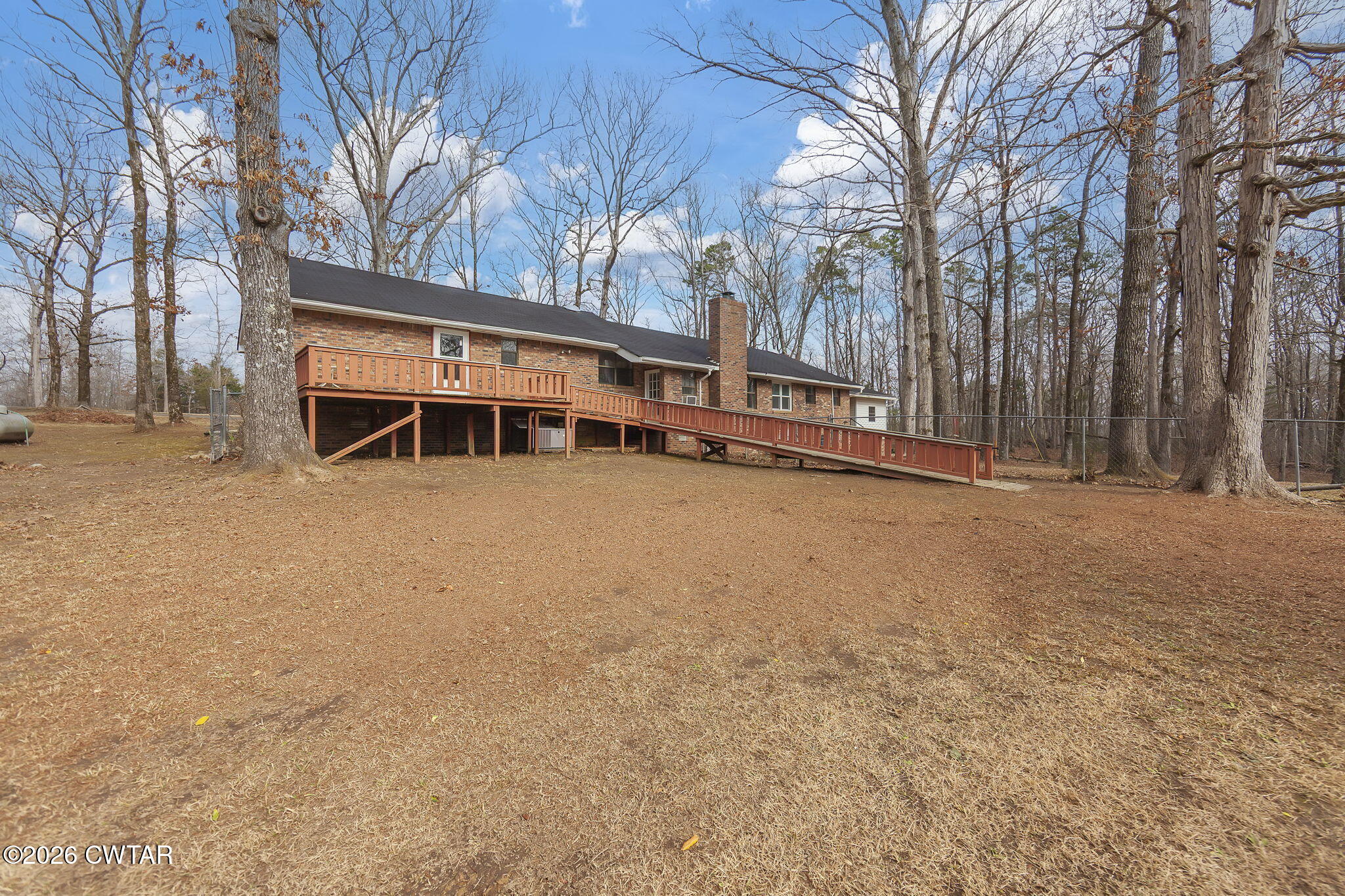 192 New Salem Road Bethel Springs, TN 38315 - Photo 25 of 32 a view of a house with a large trees and wooden fence