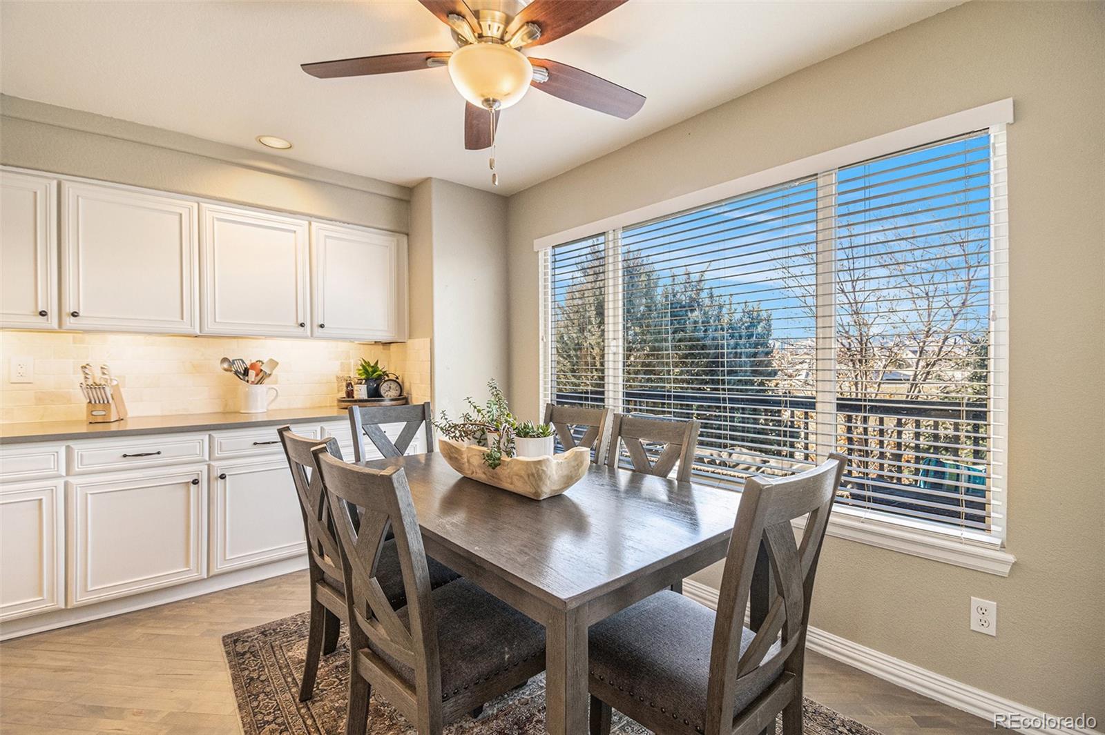 2135 Fox Fire Street Highlands Ranch, CO 80129 - Photo 8 of 40 a view of a dining room with furniture window and wooden floor