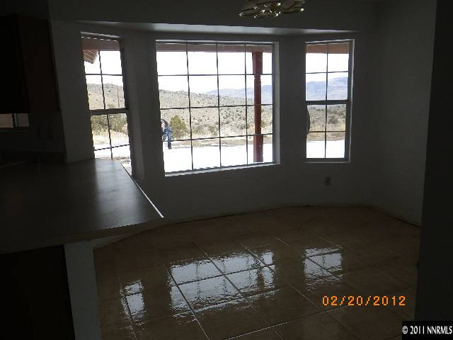 3230 Outback Lane Reno, NV 89510 - Photo 4 of 13 an empty room with wooden floor and windows