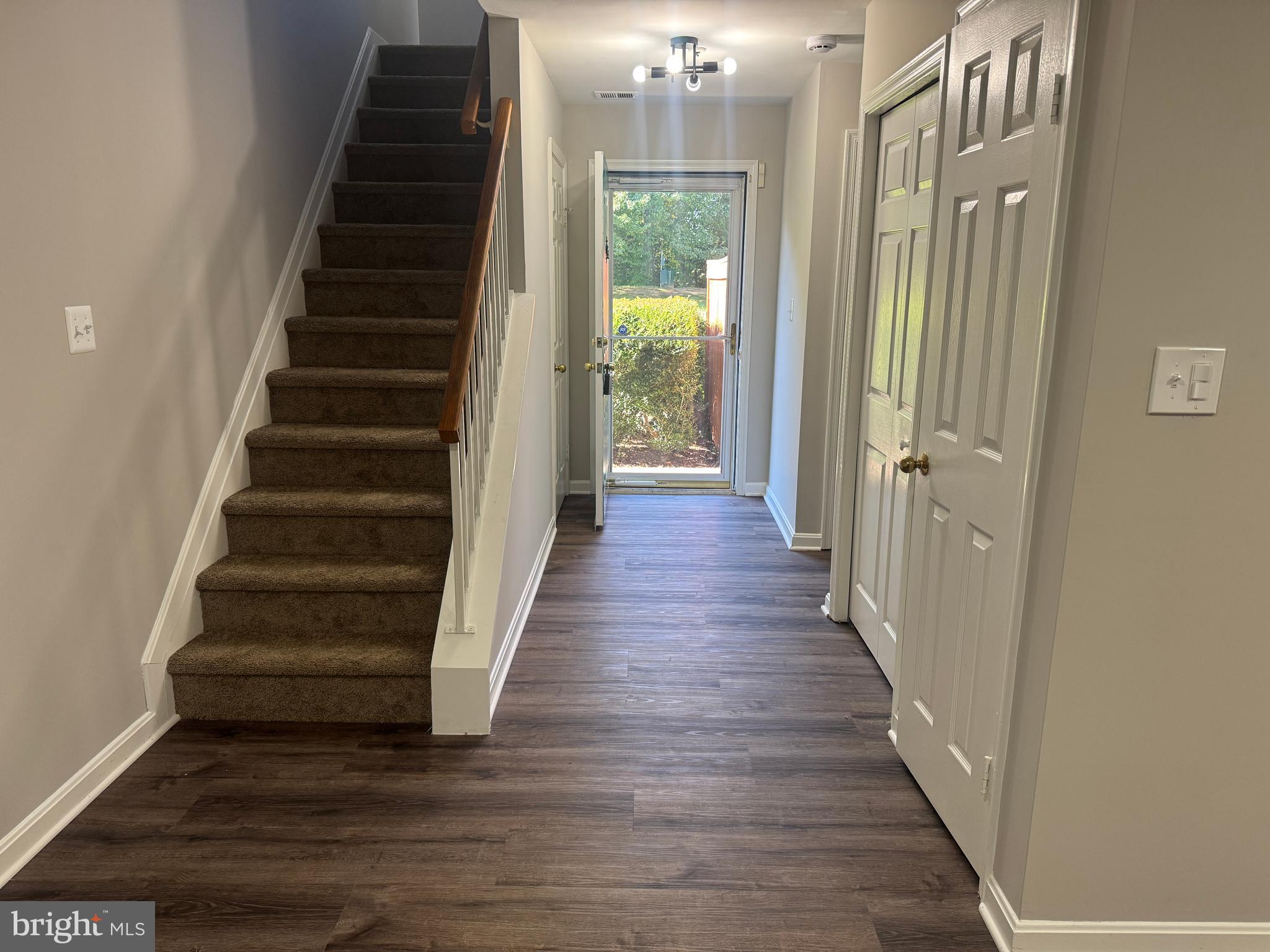 11263 Raging Brook Drive, Unit 253 Bowie, MD 20720 - Photo 15 of 22 a view of a hallway with wooden floor and windows
