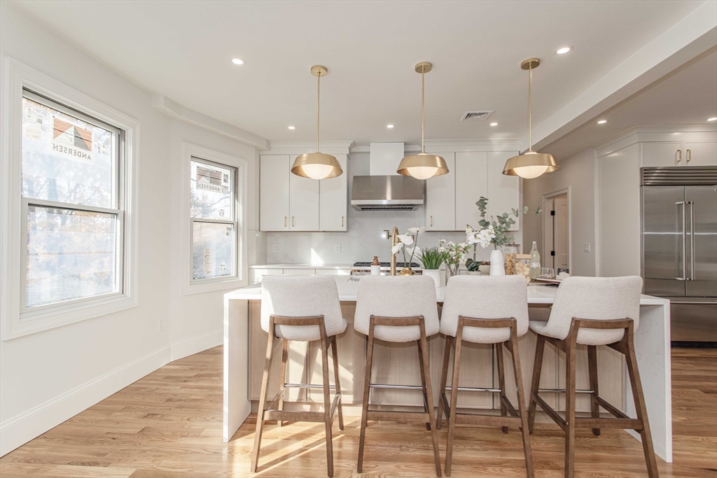 125 Mt Vernon Street, Unit 2 Newton, MA 02465 - Photo 5 of 36 a large kitchen with a table and chairs