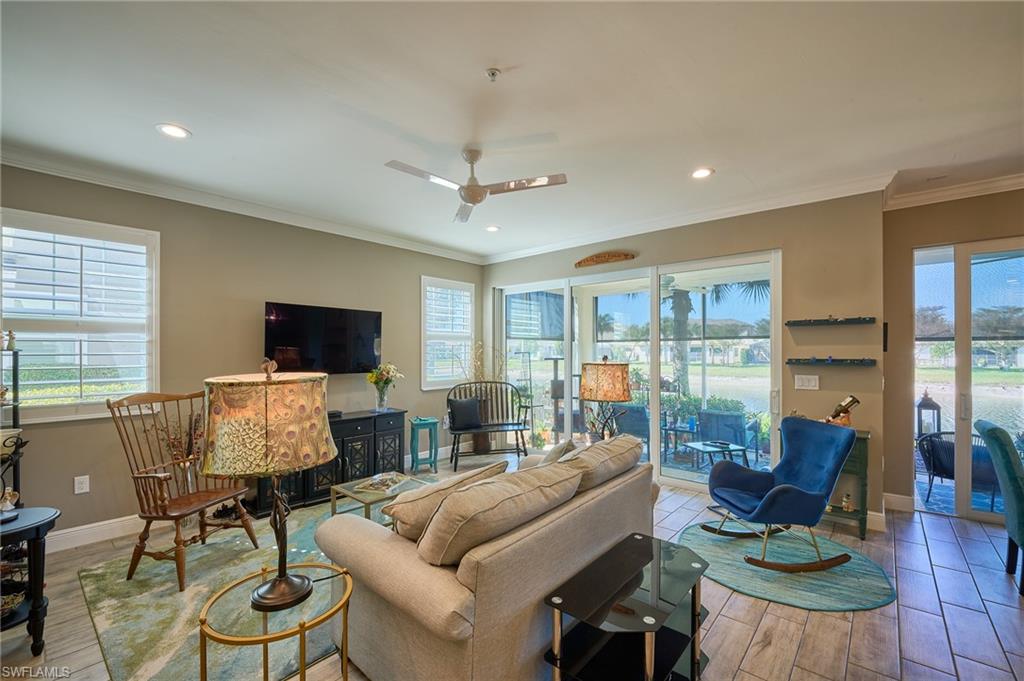 2319 Sawyers Hill Road, Unit 701 Naples, FL 34120 - Photo 11 of 36 a living room with furniture and a flat screen tv