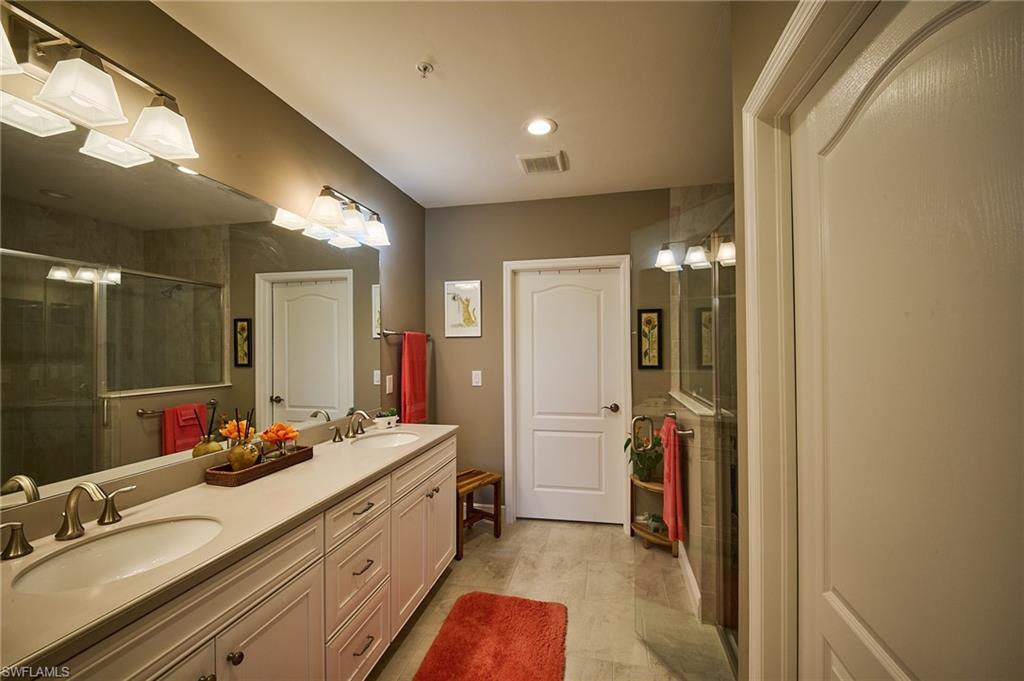 2319 Sawyers Hill Road, Unit 701 Naples, FL 34120 - Photo 14 of 36 a bathroom with a double vanity sink and a mirror