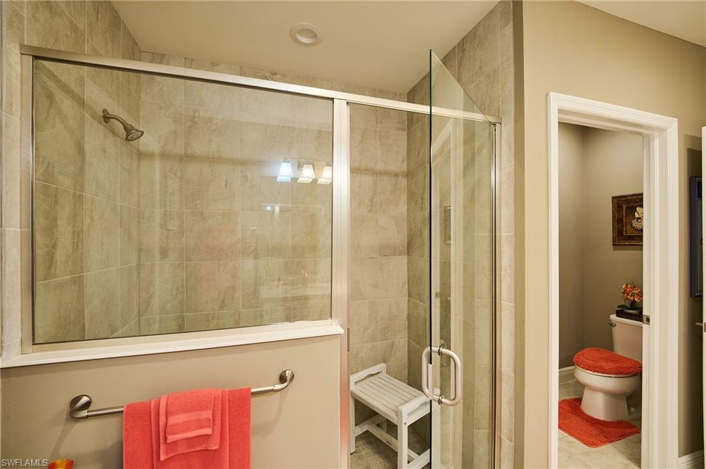 2319 Sawyers Hill Road, Unit 701 Naples, FL 34120 - Photo 15 of 36 a bathroom with a shower curtain and a sink