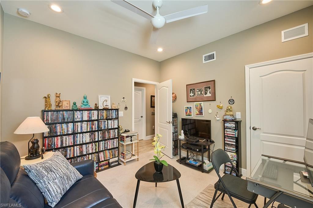 2319 Sawyers Hill Road, Unit 701 Naples, FL 34120 - Photo 17 of 36 a living room with furniture a flat screen tv and a fireplace
