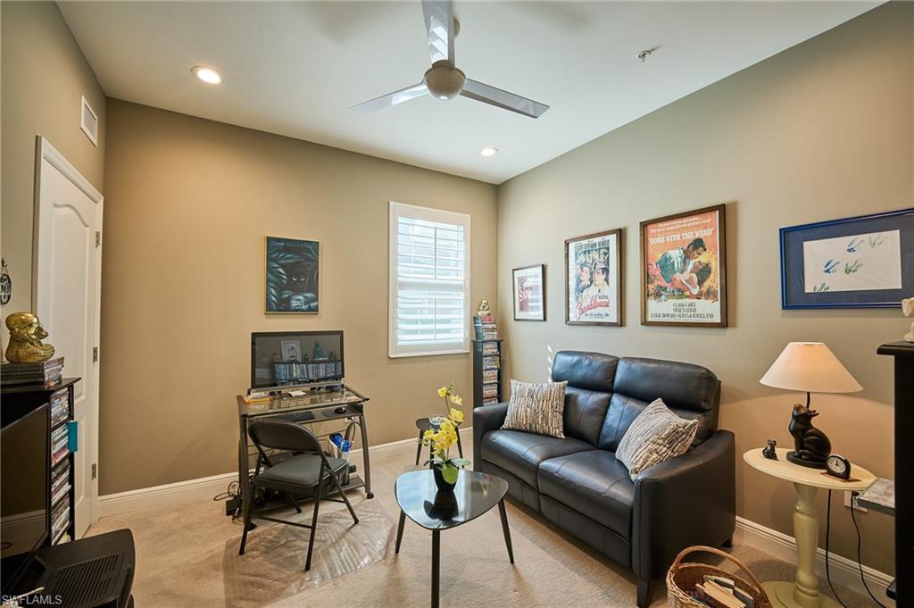 2319 Sawyers Hill Road, Unit 701 Naples, FL 34120 - Photo 18 of 36 a living room with furniture and a flat screen tv