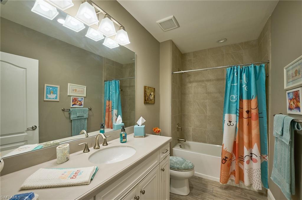 2319 Sawyers Hill Road, Unit 701 Naples, FL 34120 - Photo 19 of 36 a bathroom with a granite countertop sink toilet and shower