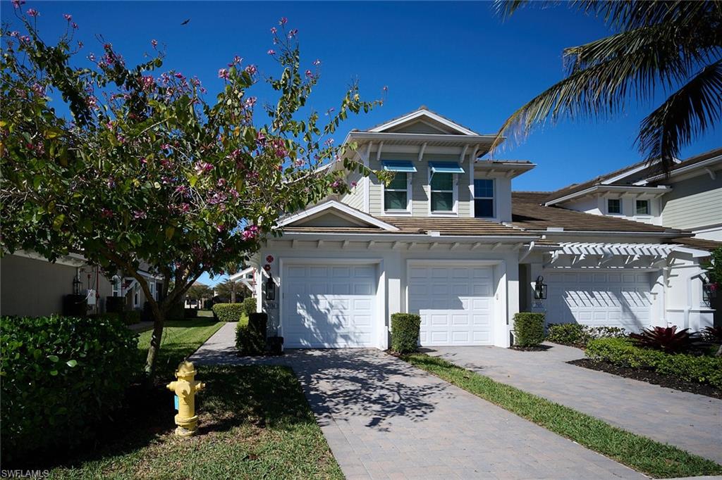 2319 Sawyers Hill Road, Unit 701 Naples, FL 34120 - Photo 2 of 36 a front view of a house with a yard