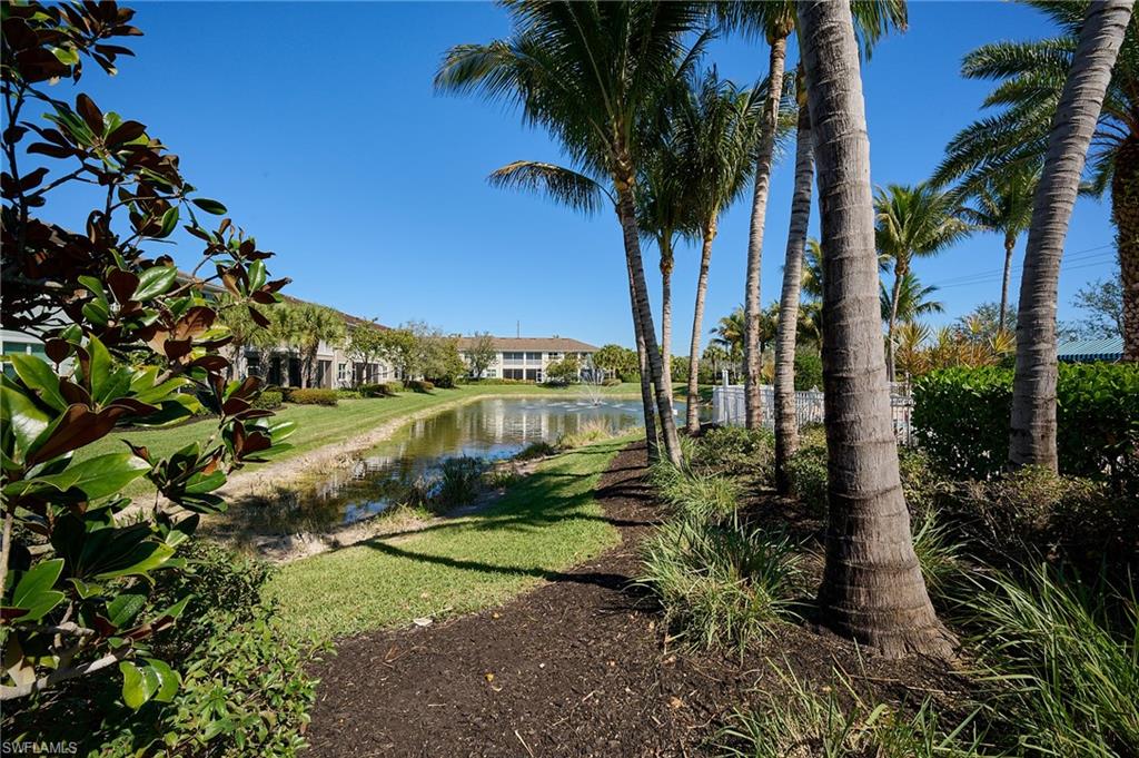 2319 Sawyers Hill Road, Unit 701 Naples, FL 34120 - Photo 30 of 36 a view of a lake with a yard