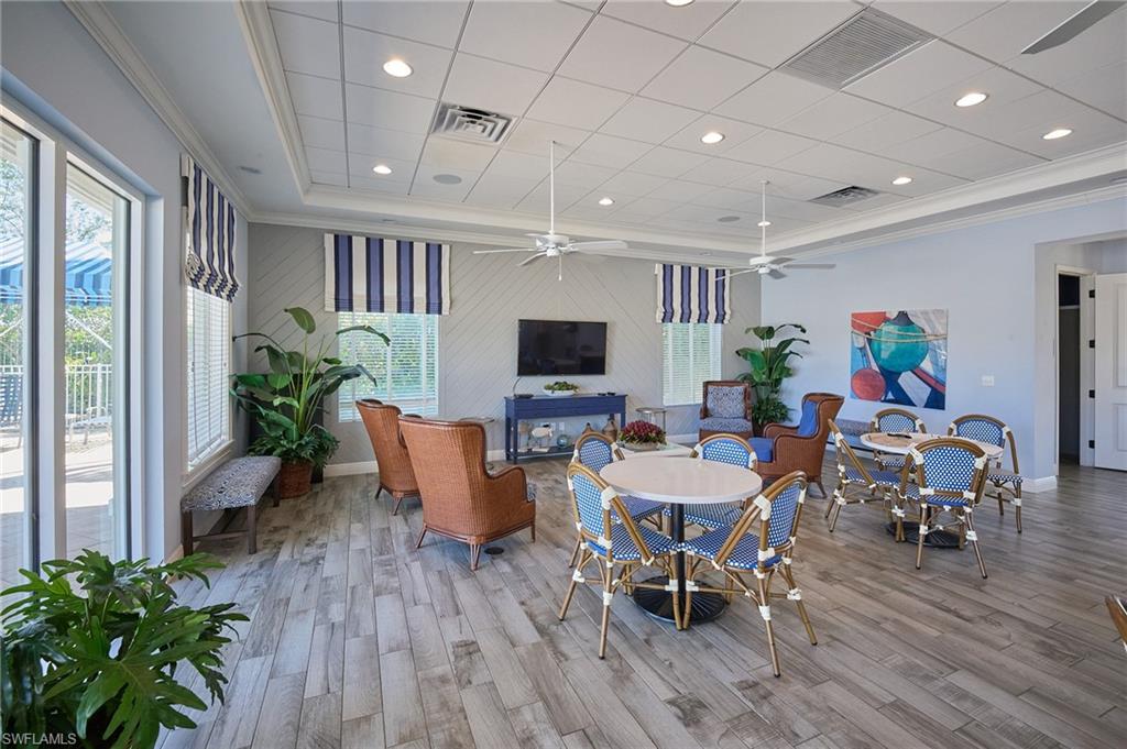 2319 Sawyers Hill Road, Unit 701 Naples, FL 34120 - Photo 33 of 36 a view of a dining room with furniture window and wooden floor