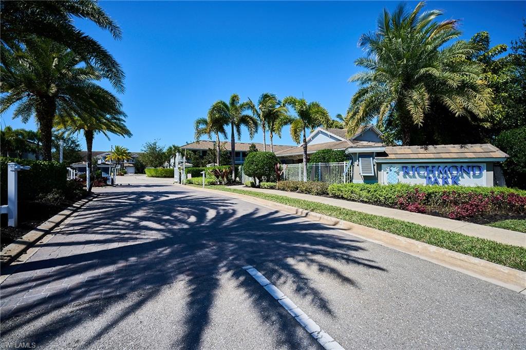 2319 Sawyers Hill Road, Unit 701 Naples, FL 34120 - Photo 36 of 36 a view of a house with a yard and palm trees