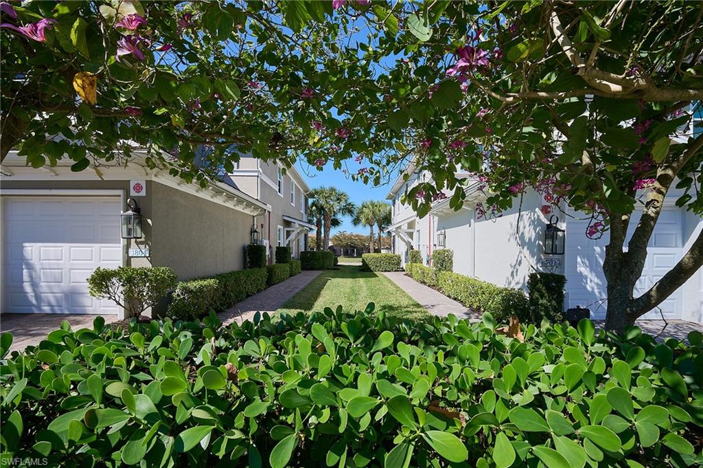 2319 Sawyers Hill Road, Unit 701 Naples, FL 34120 - Photo 4 of 36 a view of a tree in front of a house