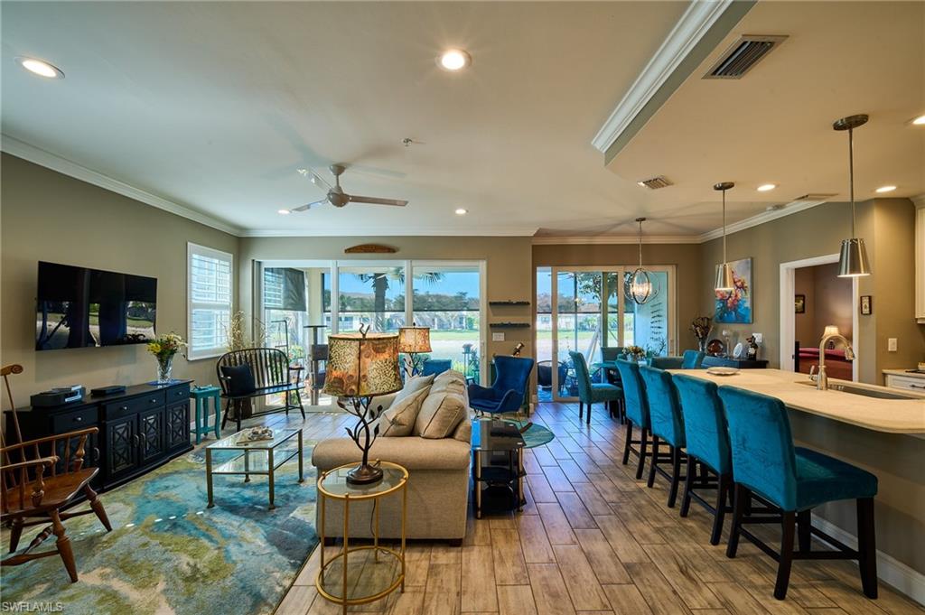 2319 Sawyers Hill Road, Unit 701 Naples, FL 34120 - Photo 7 of 36 a living room with furniture dining room and a flat screen tv
