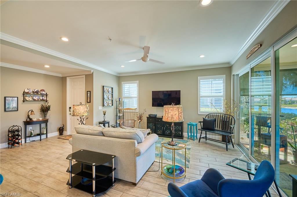 2319 Sawyers Hill Road, Unit 701 Naples, FL 34120 - Photo 9 of 36 a living room with furniture and a flat screen tv